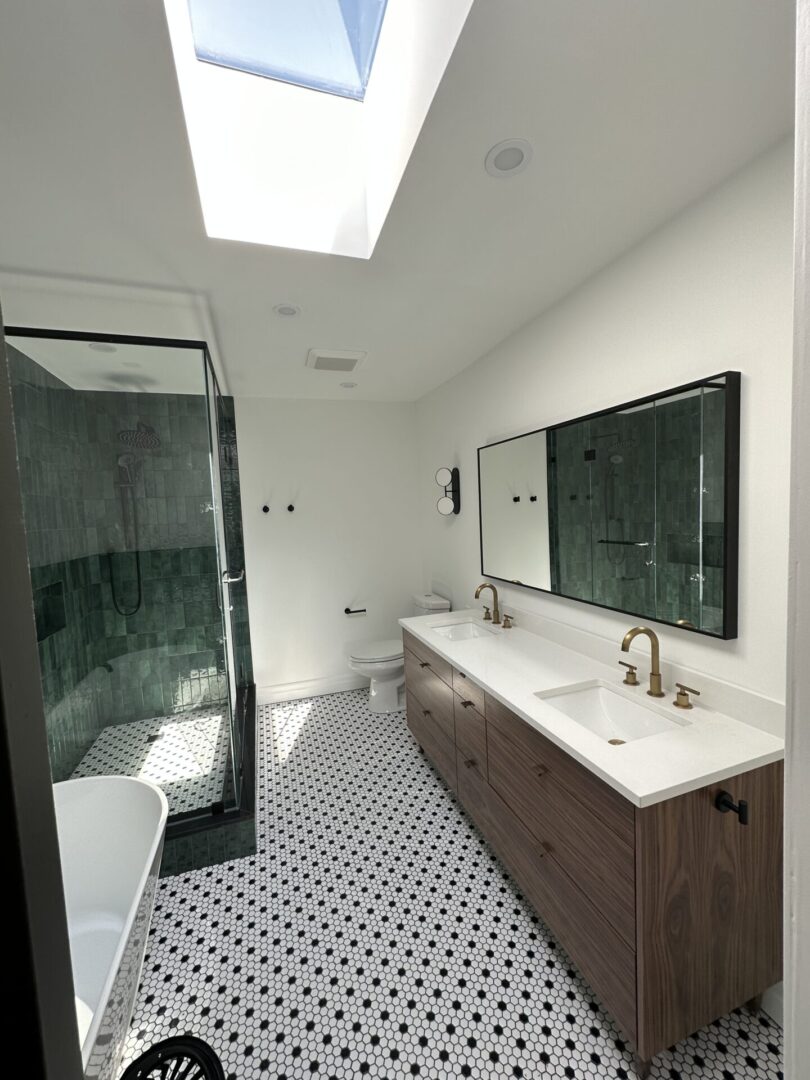 Modern bathroom with skylight and double sink.