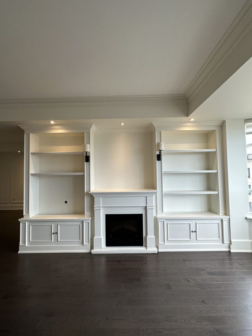 White built-in shelves with a fireplace.