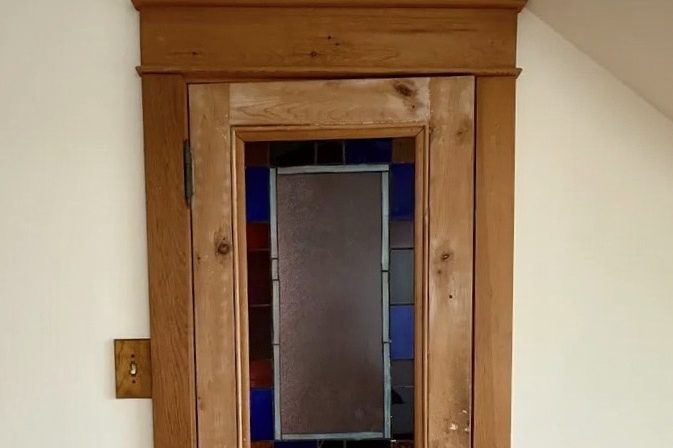 Wood-framed mirror with frosted glass and blue accents.