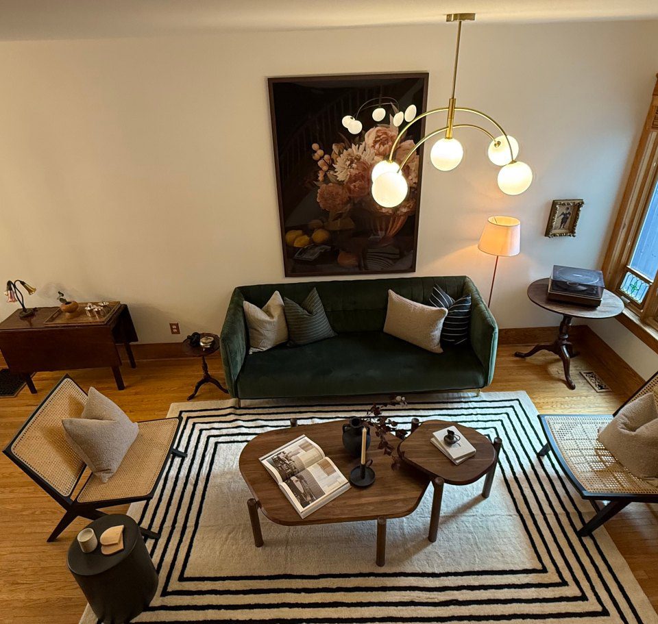 Cozy living room with green sofa and modern decor.