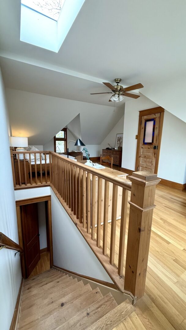 Wooden staircase railing in a cozy home interior.