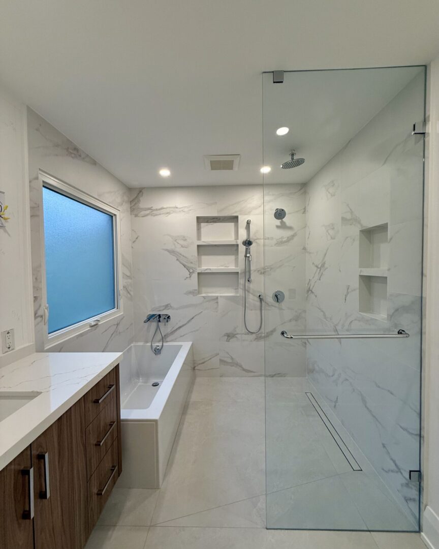 Modern bathroom with glass shower and freestanding bathtub.