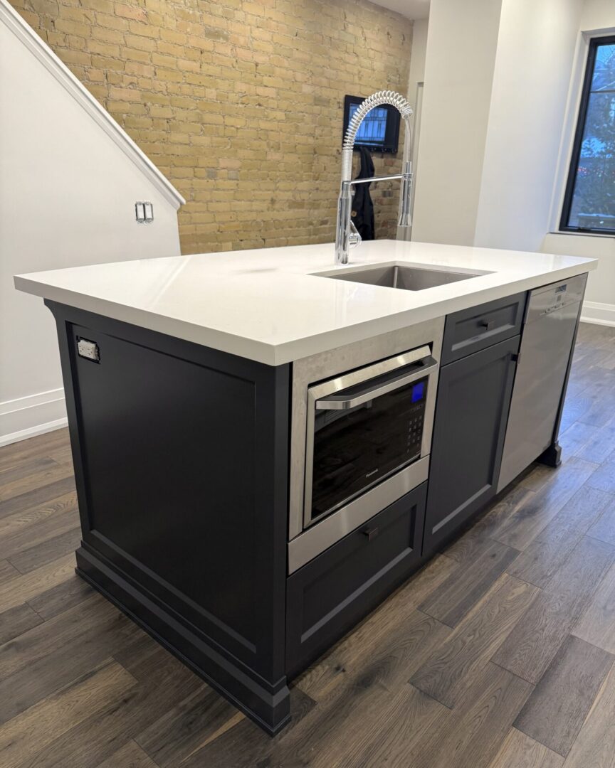 Modern kitchen island with sink and built-in microwave.
