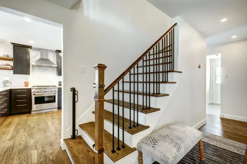Wooden staircase and modern kitchen interior.